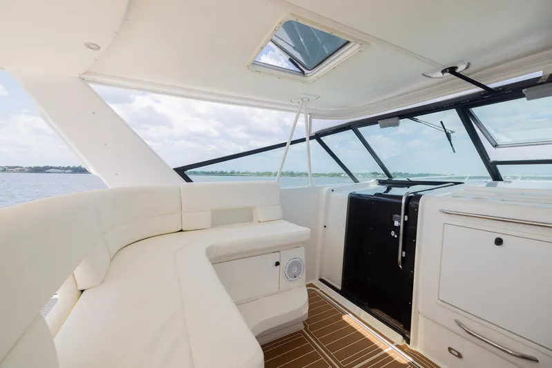 Mar's Bar Yacht Photos Pics Interior of 2000 Tiara Yachts Open model with white seating and panoramic windows.