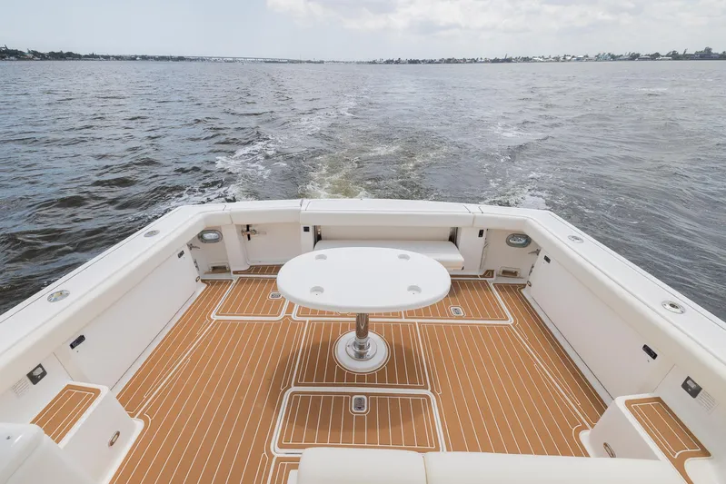 Mar's Bar Yacht Photos Pics 2000 Tiara Yachts Open model, spacious deck with table, cruising on open water.