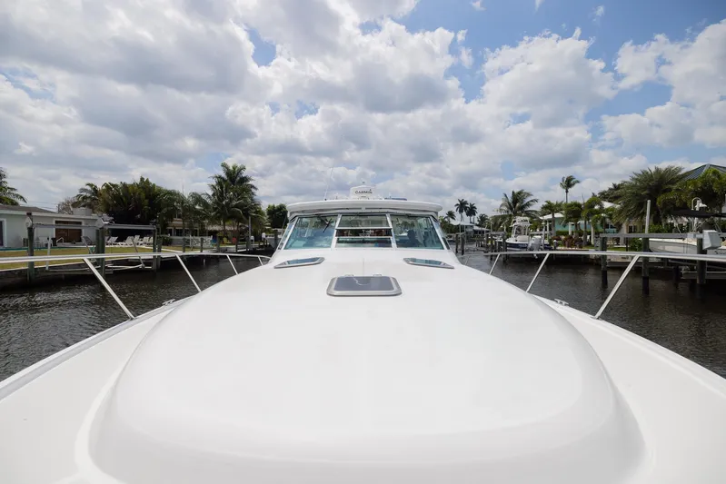 Mar's Bar Yacht Photos Pics 2000 Tiara Yachts Open model docked in a marina under a partly cloudy sky.