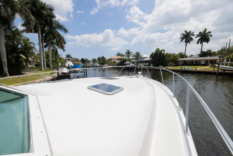 Mar's Bar Yacht Photos Pics Bow view of 2000 Tiara Yachts Open on a sunny day in a canal.