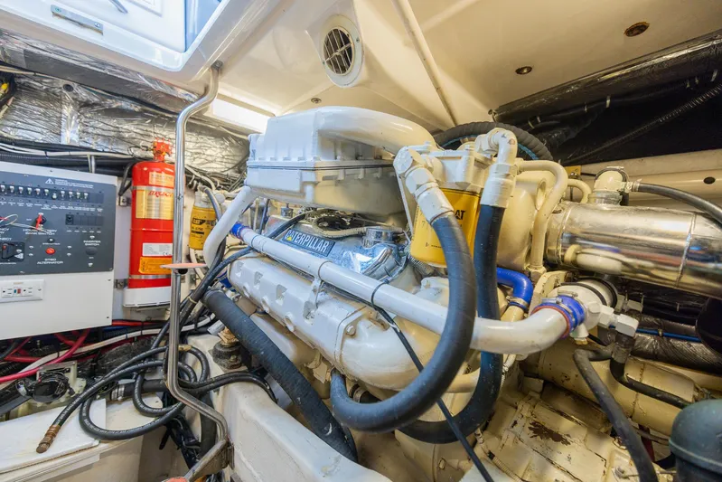 Mar's Bar Yacht Photos Pics Engine room of a 2000 Tiara Yachts Open model with visible machinery and fire extinguisher.