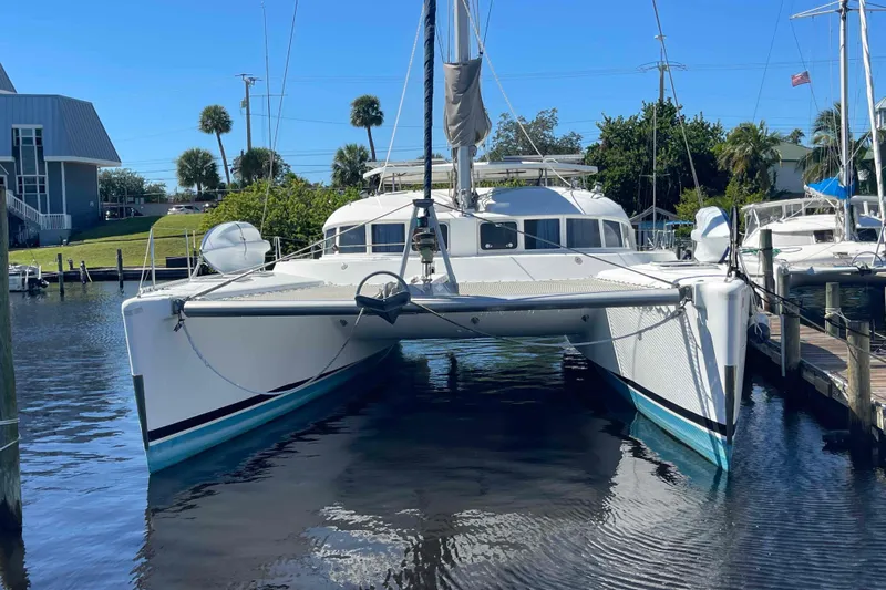 Acushla Yacht Photos Pics 2003 Lagoon 410-S2 catamaran docked in a sunny marina setting.