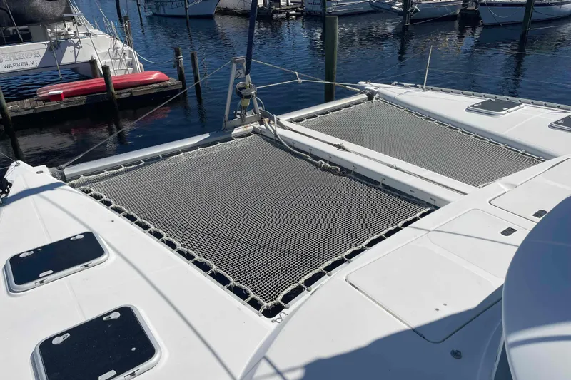 Acushla Yacht Photos Pics 2003 Lagoon 410-S2 catamaran with netted deck, docked at marina.