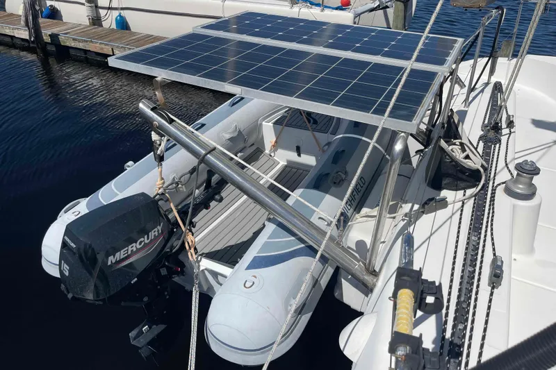 Acushla Yacht Photos Pics Lagoon 410-S2 catamaran with solar panels and dinghy, docked at marina, 2003 model.