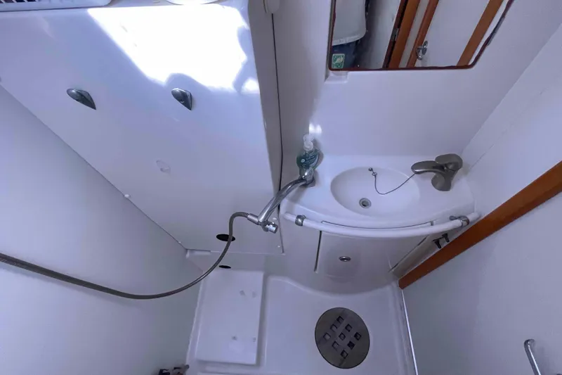 Acushla Yacht Photos Pics Compact bathroom in 2003 Lagoon 410-S2 yacht with sink and shower.