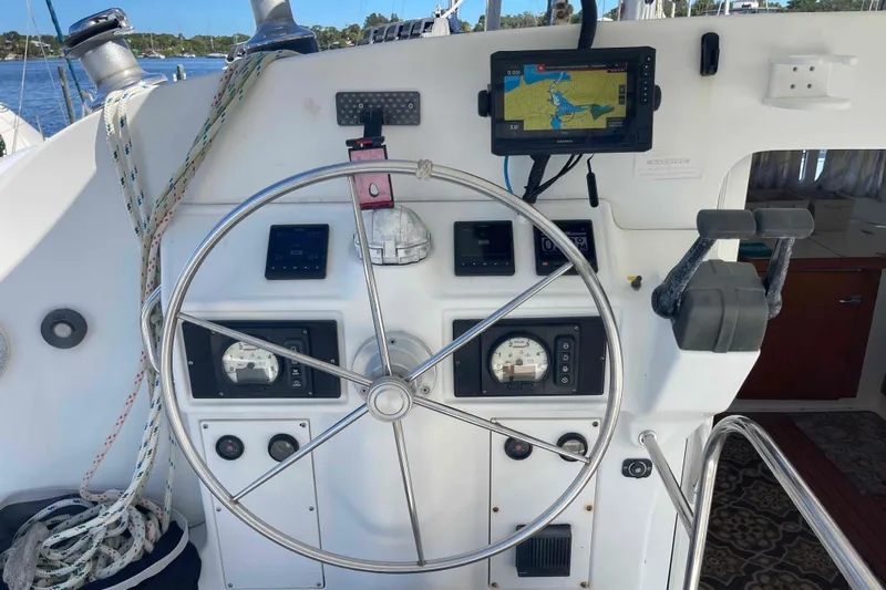 Acushla Yacht Photos Pics Steering wheel and navigation controls on a 2003 Lagoon 410-S2 catamaran.
