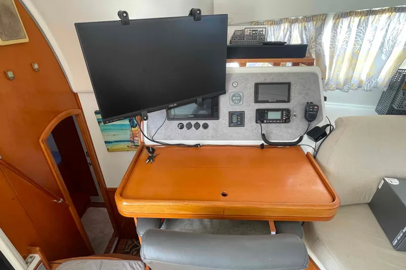 Acushla Yacht Photos Pics Navigation station in 2003 Lagoon 410-S2 catamaran with monitor and communication equipment.