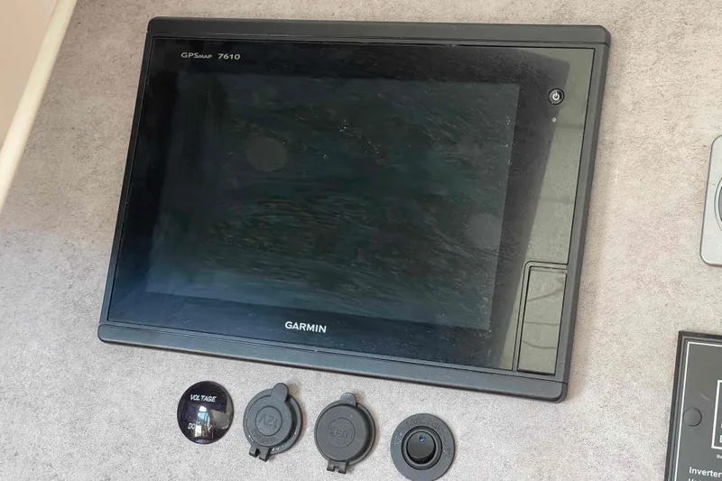 Acushla Yacht Photos Pics Garmin GPSMAP 7610 on 2003 Lagoon 410-S2 yacht dashboard with voltage and USB ports.