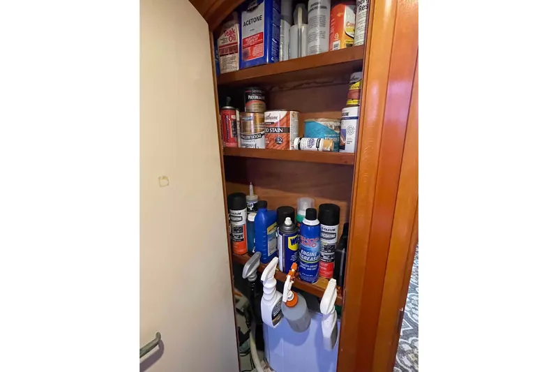 Acushla Yacht Photos Pics Storage cabinet with various maintenance supplies on a 2003 Lagoon 410-S2 yacht.