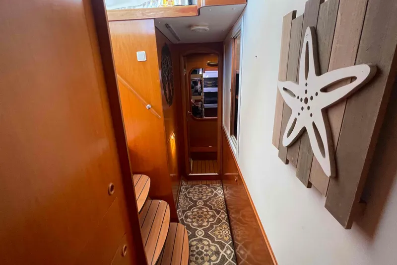 Acushla Yacht Photos Pics Interior of 2003 Lagoon 410-S2 yacht with wooden decor and starfish wall art.