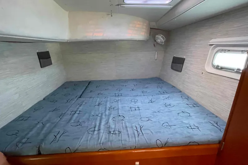 Acushla Yacht Photos Pics Cozy cabin interior of 2003 Lagoon 410-S2 catamaran with patterned bedding.