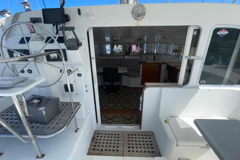Acushla Yacht Photos Pics Interior view of 2003 Lagoon 410-S2 catamaran, featuring helm and spacious cabin.