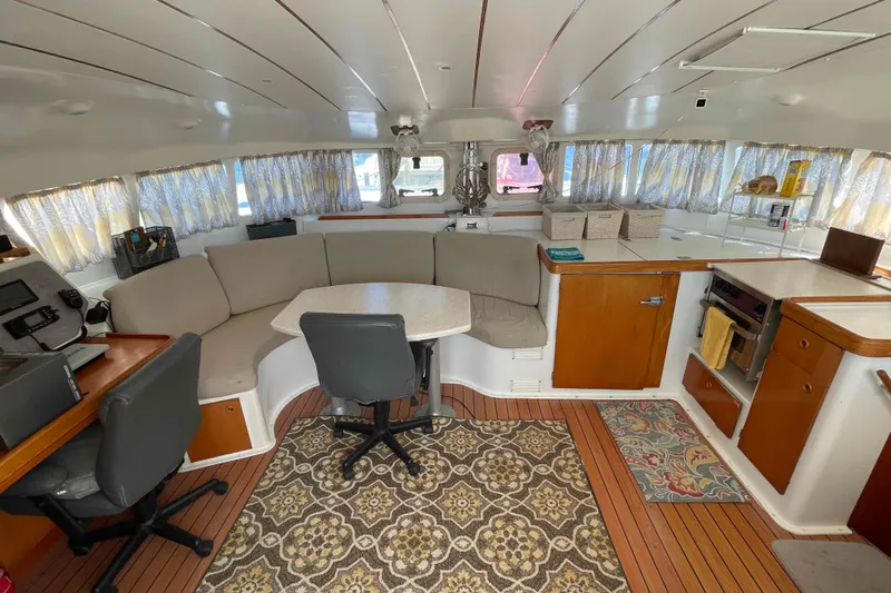 Acushla Yacht Photos Pics Interior of 2003 Lagoon 410-S2 catamaran with cozy seating and nautical decor.