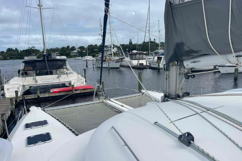 Acushla Yacht Photos Pics Catamaran Lagoon 410-S2, 2003 model, docked in a marina with other boats.
