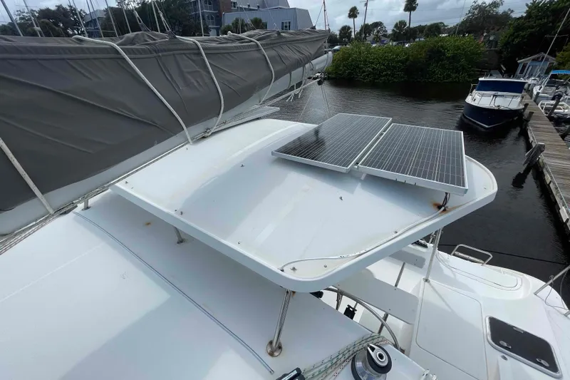 Acushla Yacht Photos Pics 2003 Lagoon 410-S2 catamaran with solar panels docked at marina.