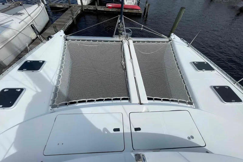 Acushla Yacht Photos Pics Front deck of a 2003 Lagoon 410-S2 catamaran with netting and hatches.