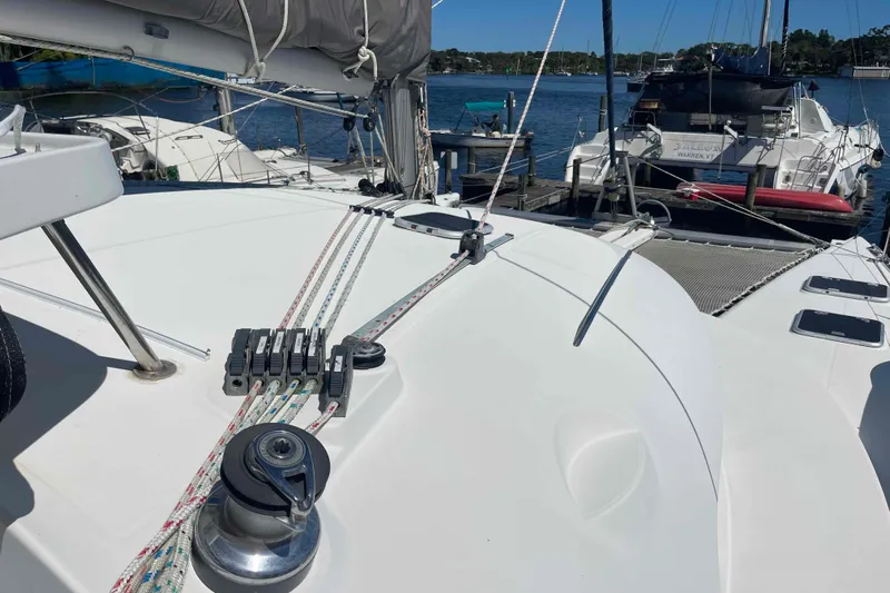 Acushla Yacht Photos Pics 2003 Lagoon 410-S2 catamaran deck with rigging, docked in a marina.