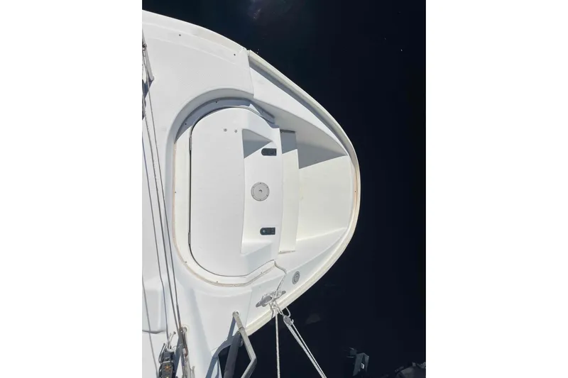 Acushla Yacht Photos Pics Bow of a 2003 Lagoon 410-S2 catamaran against dark water background.