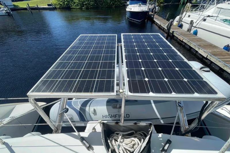 Acushla Yacht Photos Pics Solar panels on a 2003 Lagoon 410-S2 catamaran docked by the water.