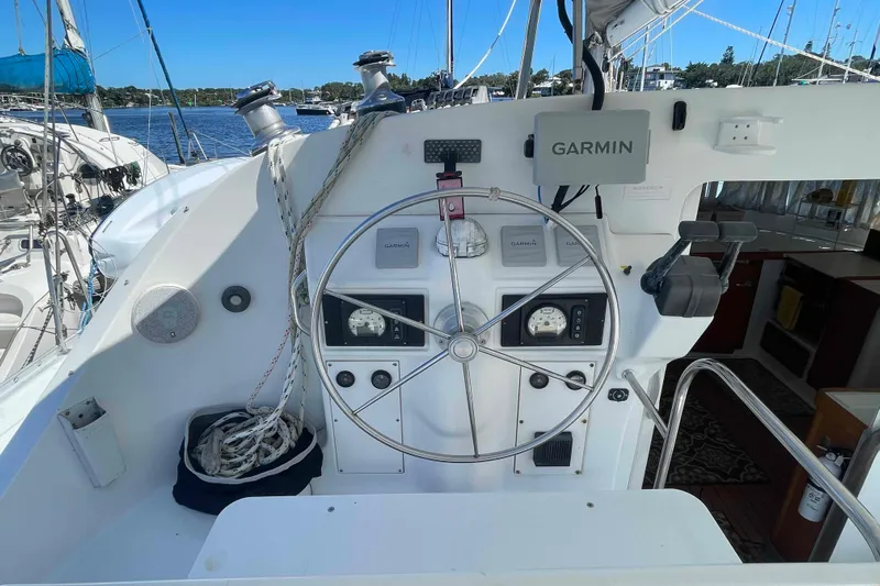 Acushla Yacht Photos Pics Helm of 2003 Lagoon 410-S2 catamaran with Garmin navigation system and steering wheel.