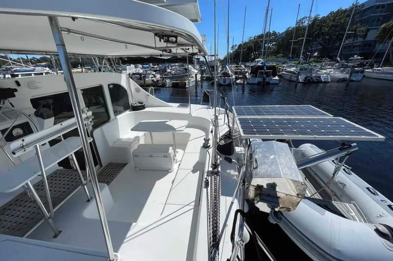 Acushla Yacht Photos Pics 2003 Lagoon 410-S2 catamaran with solar panels docked at a marina.