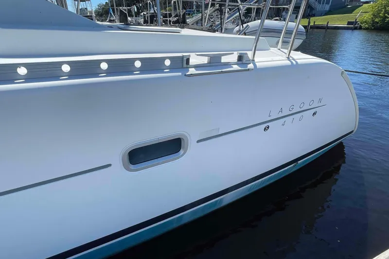 Acushla Yacht Photos Pics 2003 Lagoon 410-S2 catamaran docked, showcasing sleek white hull design.