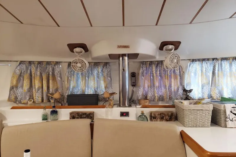 Acushla Yacht Photos Pics Interior of 2003 Lagoon 410-S2 catamaran with decorative curtains and cozy seating area.