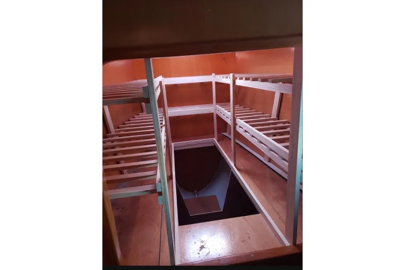 Acushla Yacht Photos Pics Interior view of 2003 Lagoon 410-S2 catamaran showing wooden bunk bed frames.