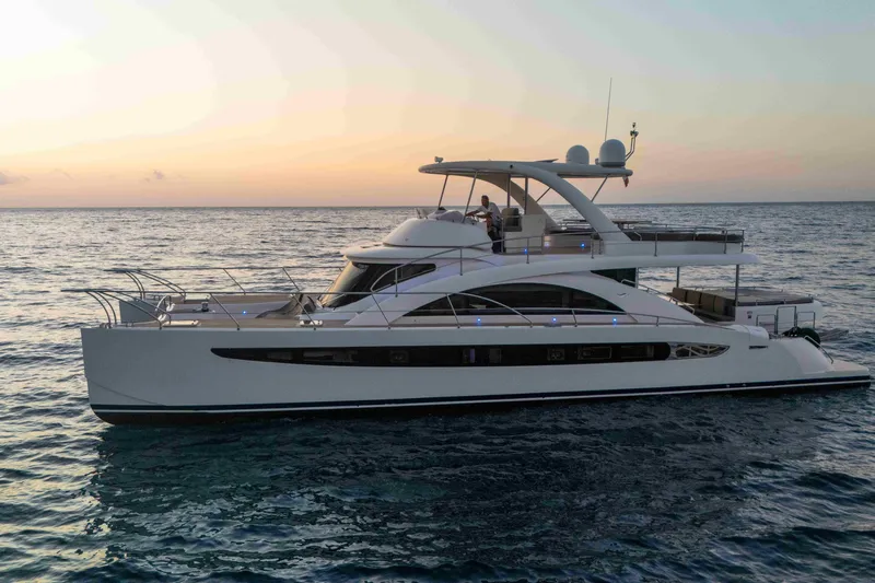 013 Yacht Photos Pics Luxurious 2008 VG 62 yacht cruising at sunset on calm ocean waters.