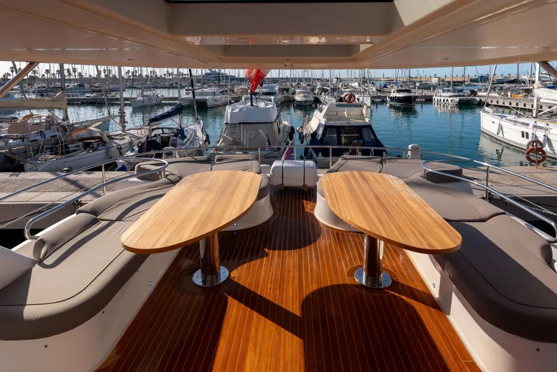 013 Yacht Photos Pics Luxurious VG 62 yacht deck with wooden tables, docked at a marina, 2008 model.