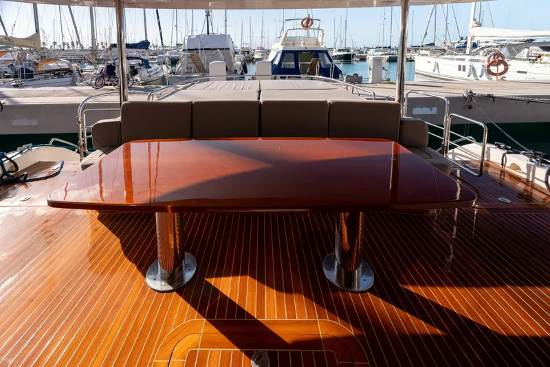 013 Yacht Photos Pics Luxurious VG 62 yacht deck with polished wood table, docked at marina, 2008 model.