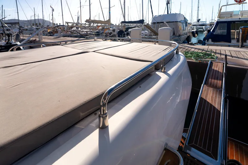 013 Yacht Photos Pics Luxurious VG 62 yacht from 2008 docked at a marina, featuring a sunbathing deck.