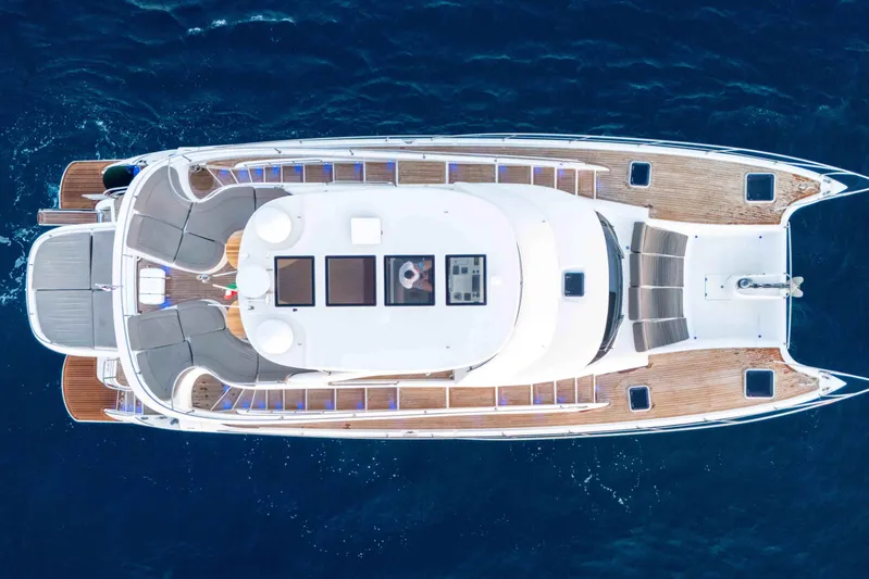 013 Yacht Photos Pics Aerial view of 2008 VG 62 yacht with wooden deck on blue ocean.