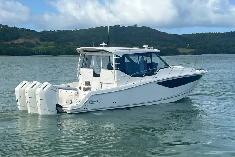  Yacht Photos Pics 2022 Boston Whaler Conquest 405 boat on water, featuring triple outboard engines.