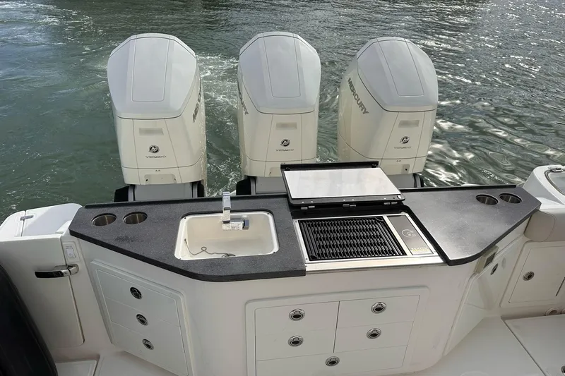  Yacht Photos Pics 2022 Boston Whaler Conquest 405 with triple Mercury engines and onboard sink and grill.