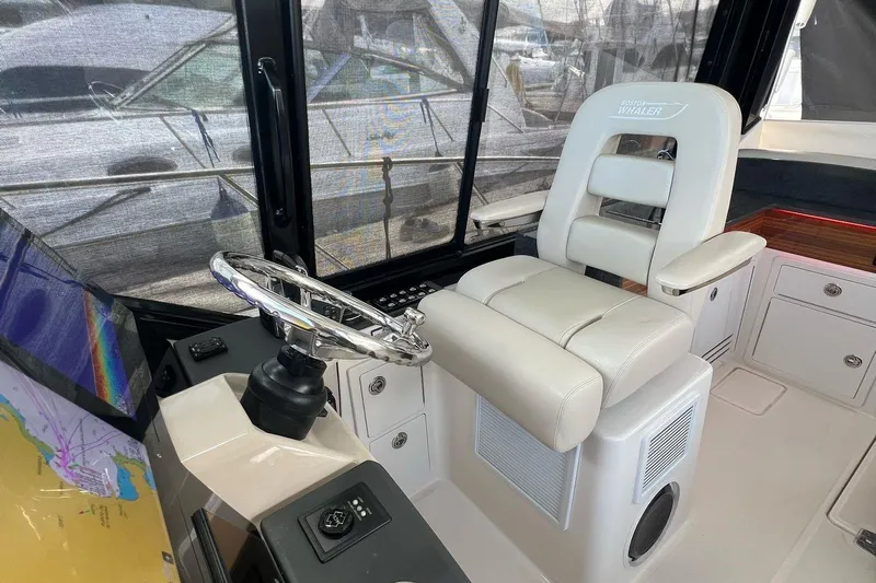  Yacht Photos Pics 2022 Boston Whaler Conquest 405 helm with luxurious seating and navigation equipment.