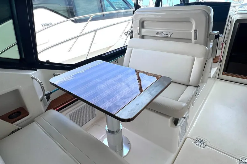  Yacht Photos Pics Interior of 2022 Boston Whaler Conquest 405 with sleek seating and table.