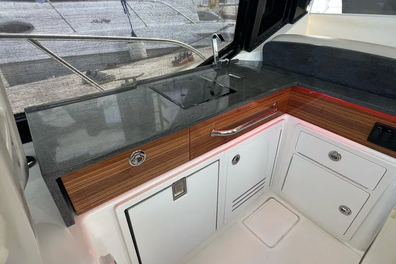  Yacht Photos Pics 2022 Boston Whaler Conquest 405 interior kitchen with sleek countertop and modern cabinetry.