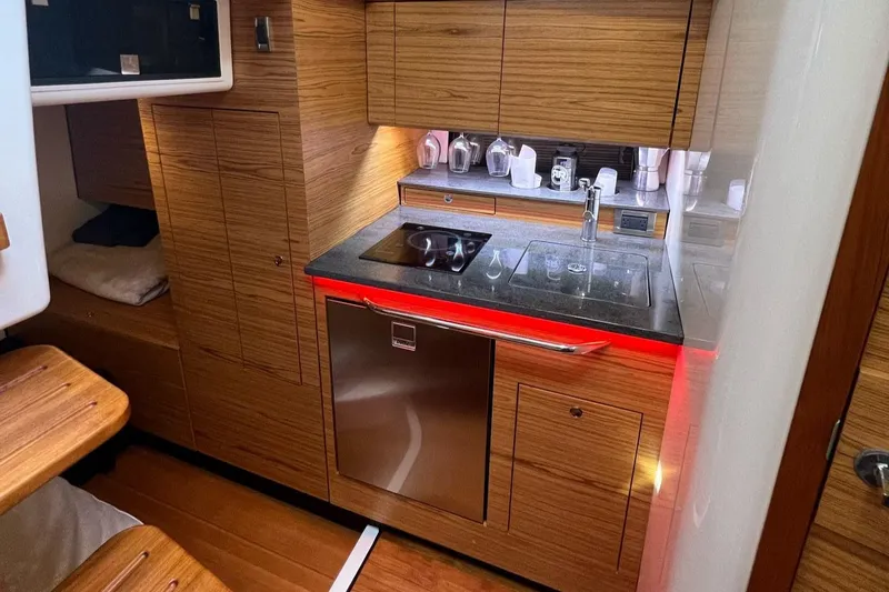  Yacht Photos Pics Luxurious kitchen interior of 2022 Boston Whaler Conquest 405 yacht with modern amenities.