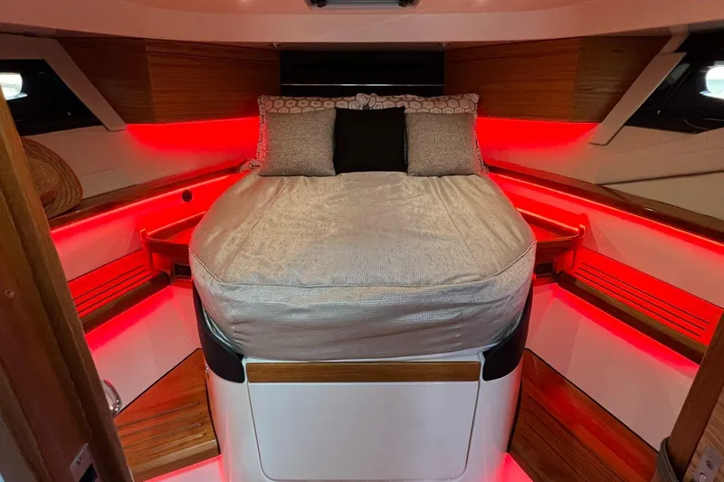  Yacht Photos Pics Luxurious cabin interior of 2022 Boston Whaler Conquest 405 with ambient red lighting.