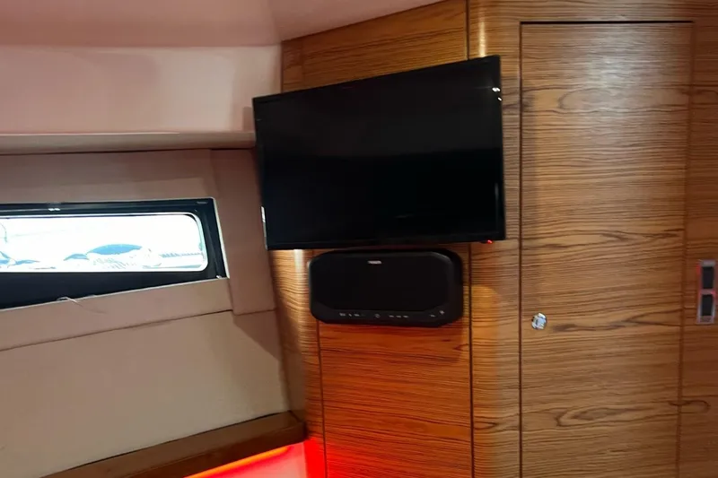  Yacht Photos Pics Interior of 2022 Boston Whaler Conquest 405 with TV and wood paneling.