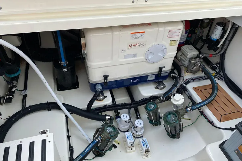  Yacht Photos Pics Engine compartment of a 2022 Boston Whaler Conquest 405, showcasing mechanical components and wiring.