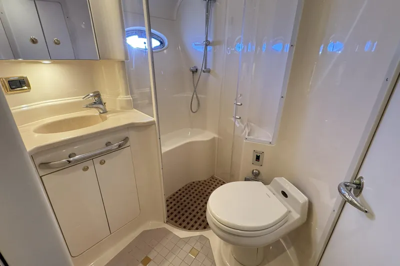  Yacht Photos Pics Luxurious bathroom in 2001 Sea Ray Sundancer 510 yacht with shower, sink, and toilet.