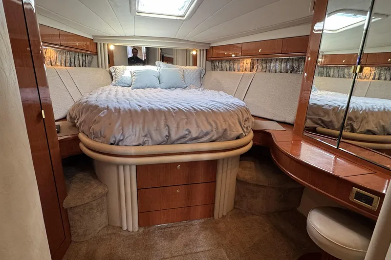  Yacht Photos Pics Luxurious 2001 Sea Ray Sundancer 510 yacht bedroom with elegant wood finish and plush bedding.