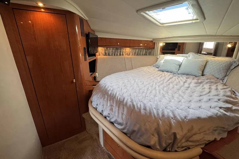  Yacht Photos Pics Luxurious bedroom interior of 2001 Sea Ray Sundancer 510 yacht with skylight and wood finishes.