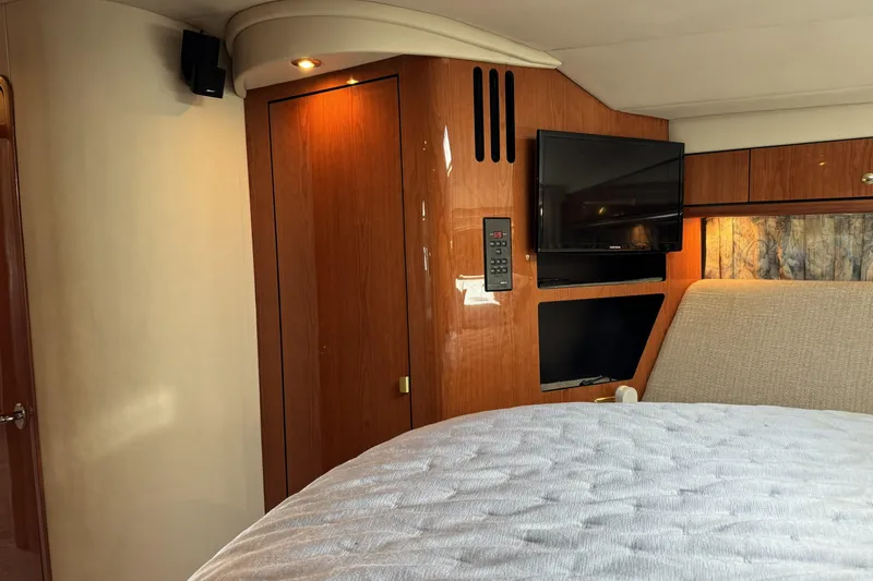  Yacht Photos Pics Interior cabin of 2001 Sea Ray Sundancer 510 yacht with wood paneling and TV.