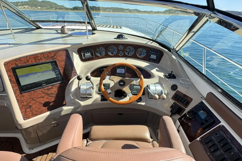  Yacht Photos Pics 2001 Sea Ray Sundancer 510 helm with navigation system, steering wheel, and control panel.
