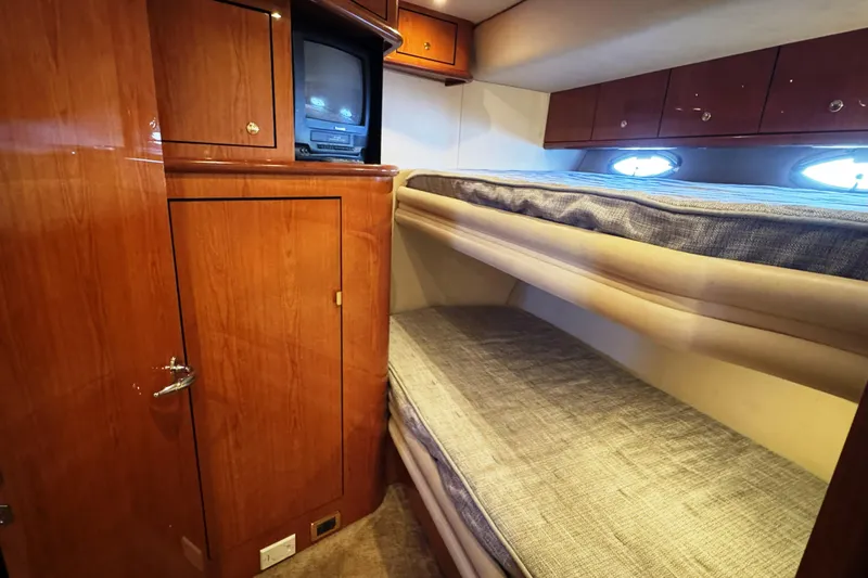  Yacht Photos Pics Interior cabin of 2001 Sea Ray Sundancer 510 with bunk beds and wooden cabinetry.