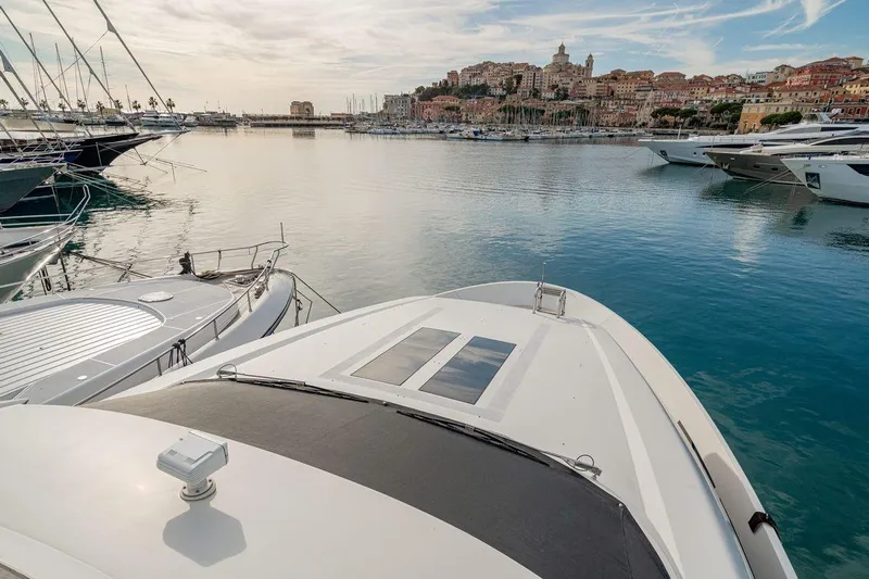 7 Seconds Yacht Photos Pics Luxury Dreamline 26 yacht docked in scenic harbor, 2015 model, with coastal town backdrop.