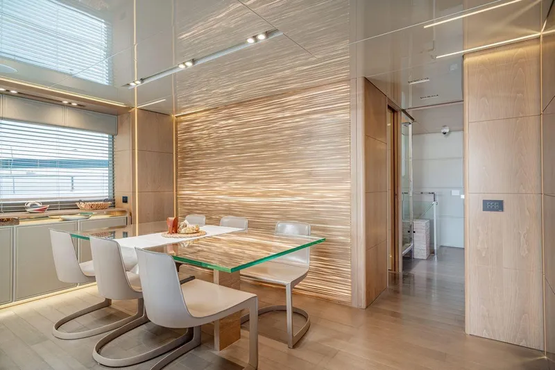 7 Seconds Yacht Photos Pics Modern dining area on 2015 Dreamline 26 yacht with sleek design and glass table.